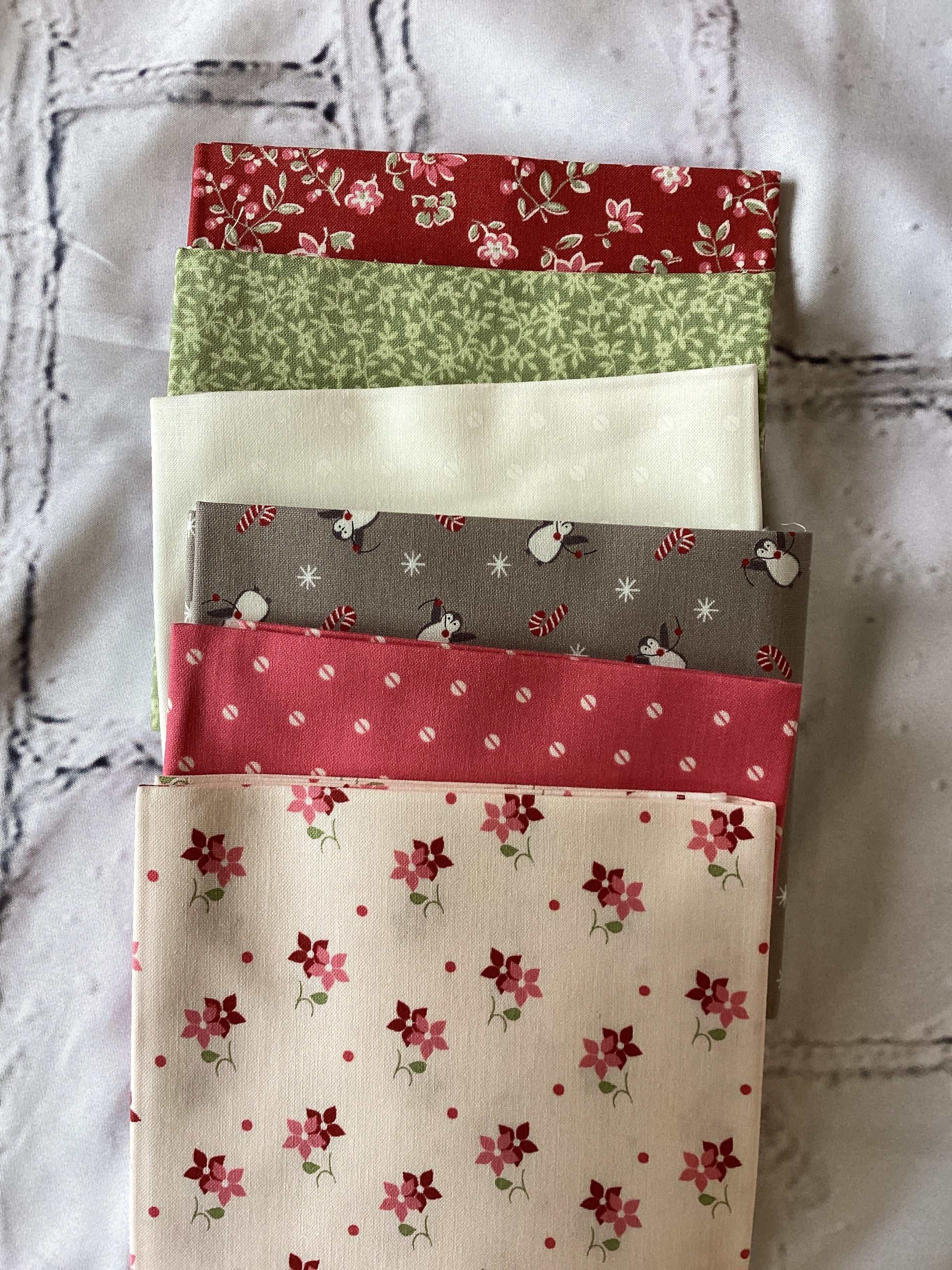 M50 Starry Night Bundle fabric squares curated by Bella Rose Quilts with floral and snowman patterns