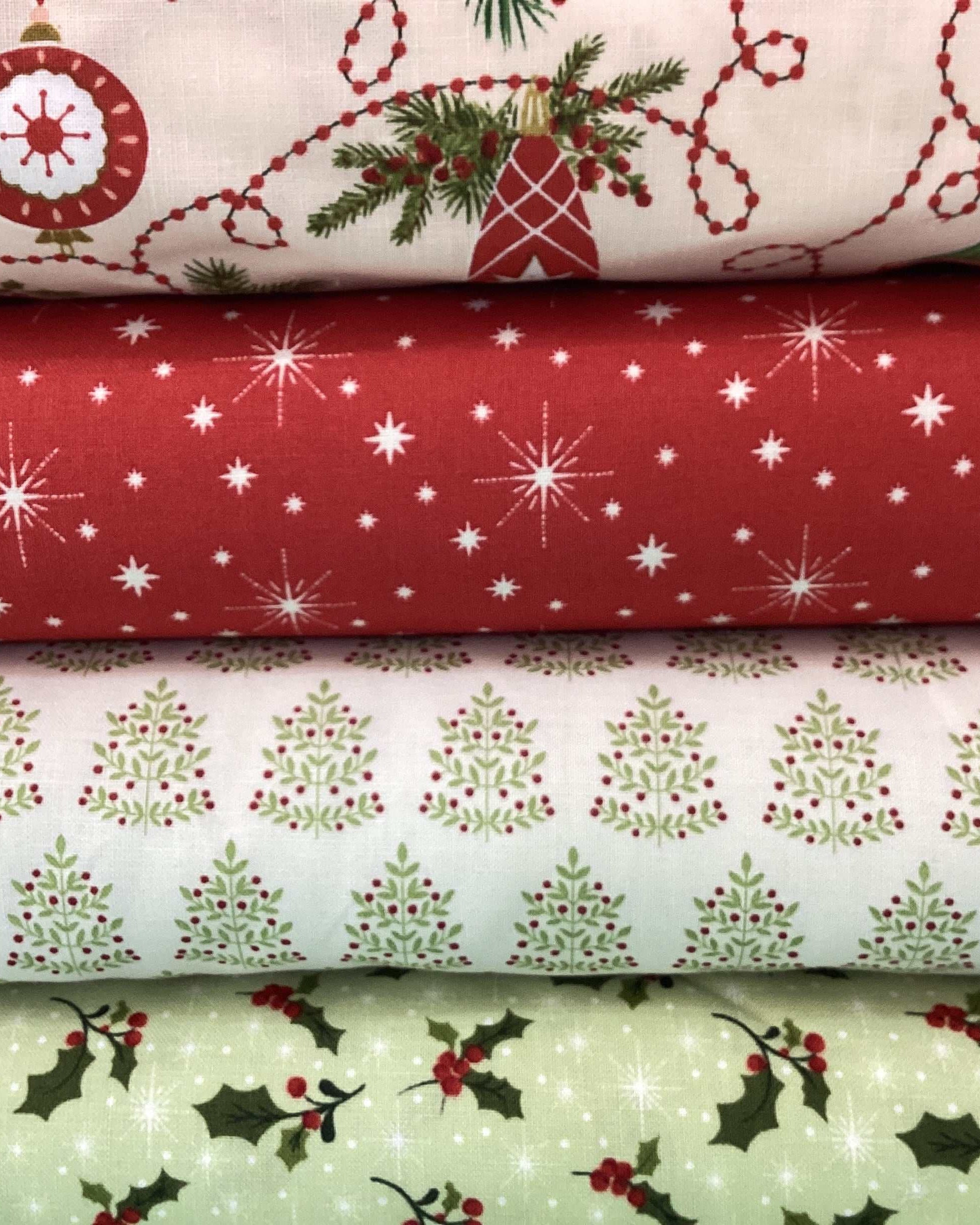 4 Yard Quilt Bundle with Christmas-themed fabric including ornaments, stars, Christmas trees, and holly designs