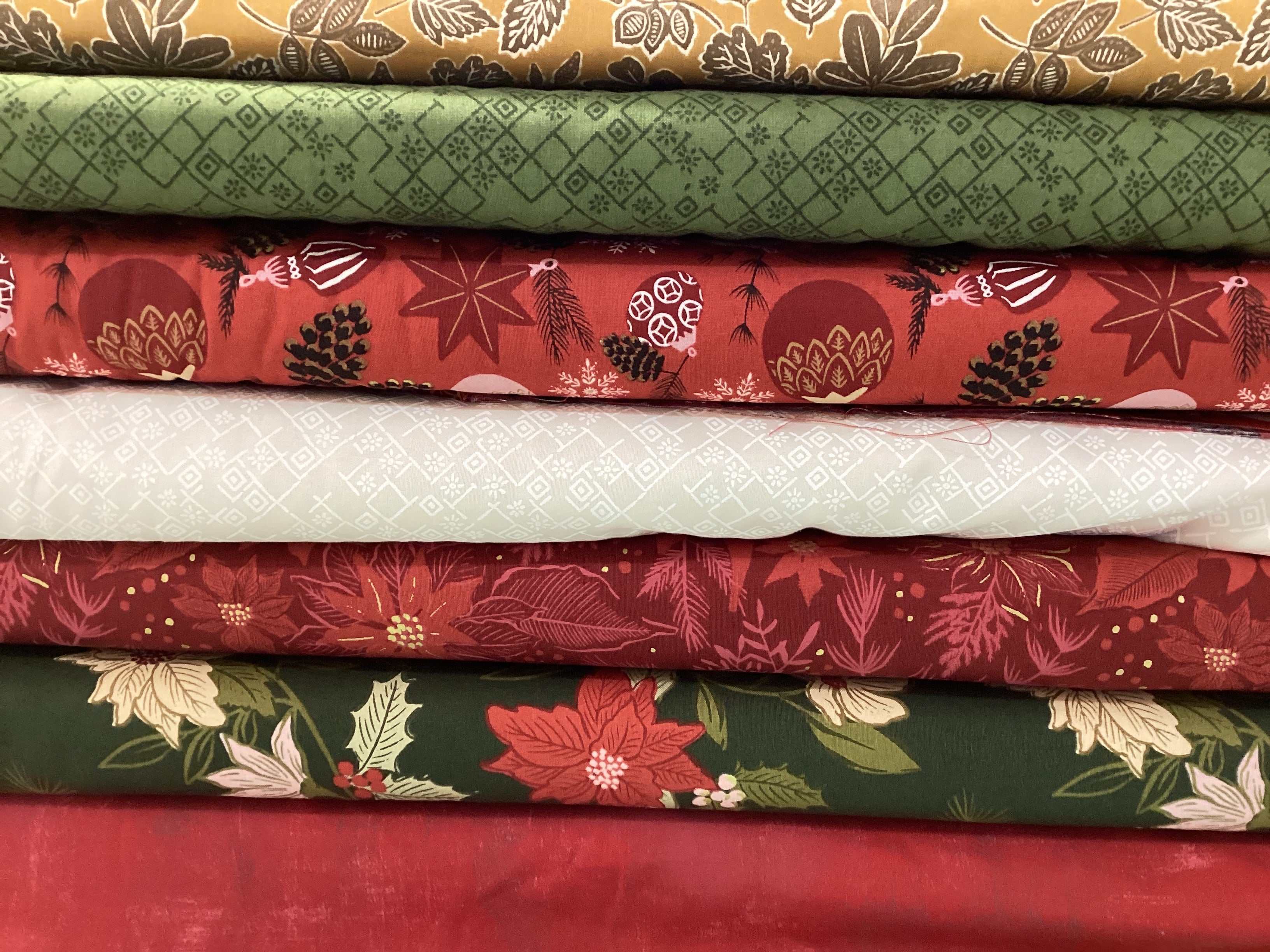 M50 Island Hopping Kit with assorted green, red, and white quilting fabrics curated by Bella Rose Quilts