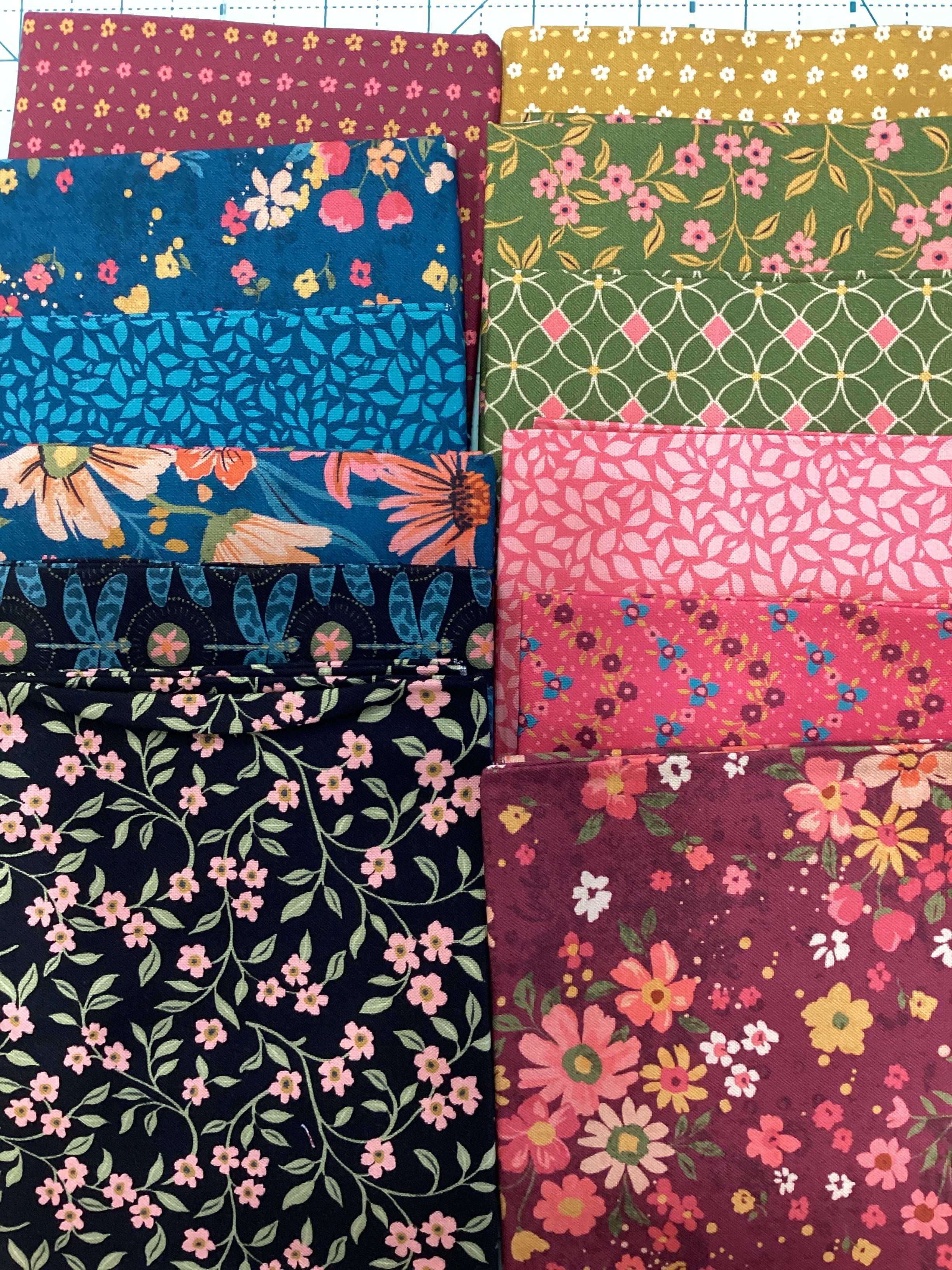 12-piece fat quarter bundle with floral and geometric fabric patterns curated by Bella Rose Quilts