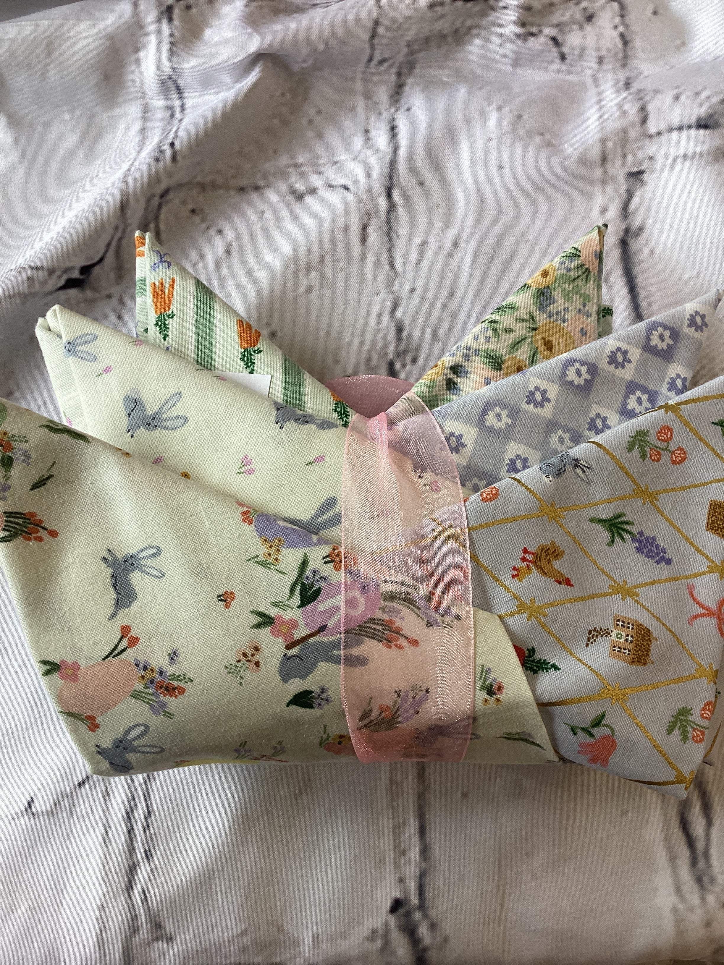 M50 Starry Night fabric bundle with floral and patterned designs wrapped with pink ribbon