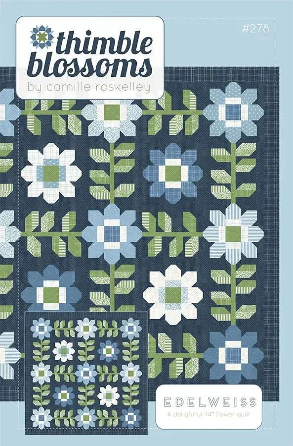 Edelweiss Quilt pattern by Thimble Blossom featuring blue and white flower blocks and green leaves on dark background.