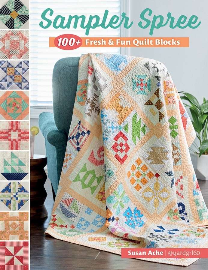Sampler Spree by Susan Ache colorful quilt with over 100 unique 6-inch blocks displayed on a chair