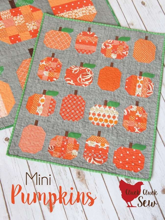 Mini Pumpkins Quilt Pattern wall hanging with orange patchwork pumpkins on gray background