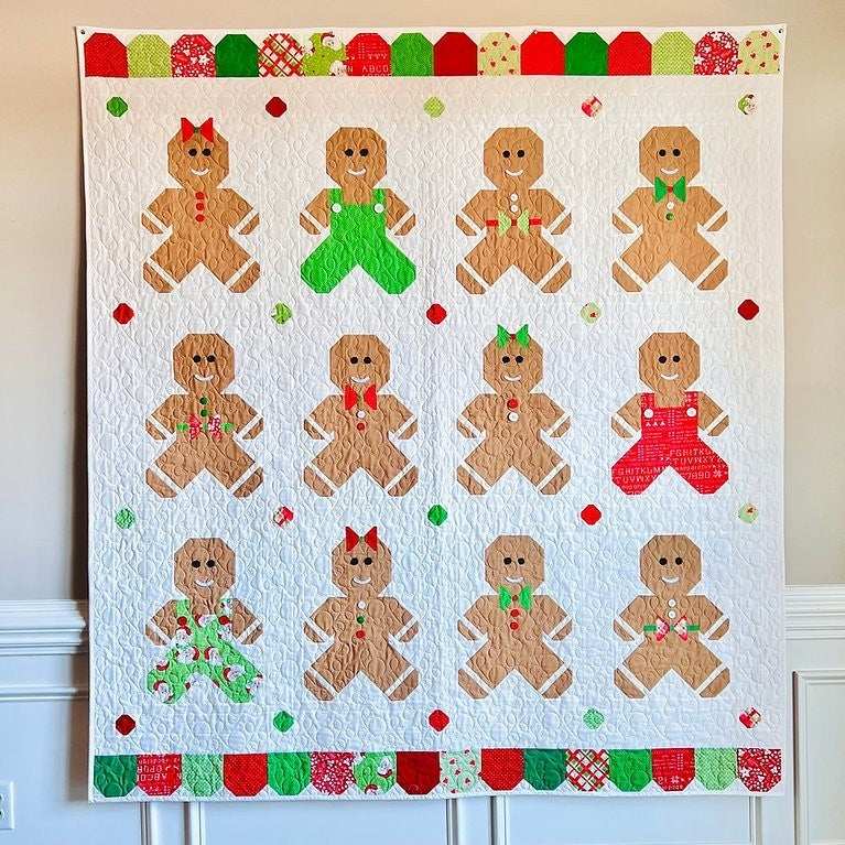 Ginger & Jolly Quilt Kit featuring gingerbread men designs in festive red, green, and white colors.