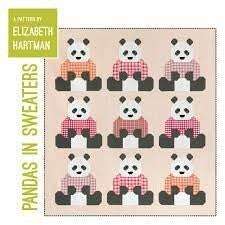 Pandas in sweaters quilt pattern with nine pandas wearing different sweaters on a grid background