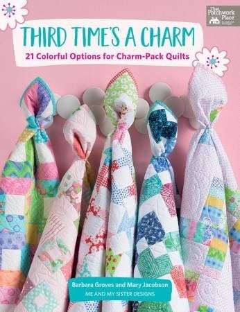 Third Time's A Charm quilt patterns with colorful 5-inch charm pack fabrics hanging on hooks