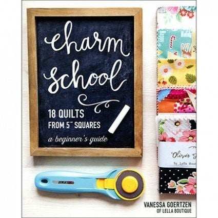 Charm School quilting book with fabric squares and rotary cutter for beginner quilters