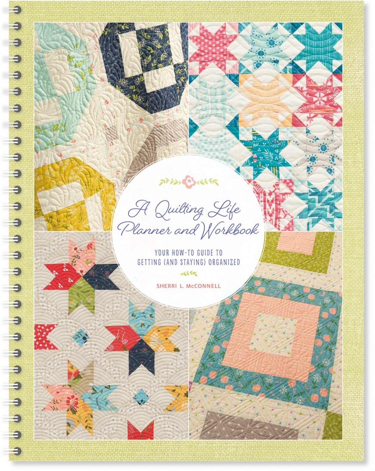 A Quilting Life Planner and Workbook cover with patchwork quilt designs and spiral binding