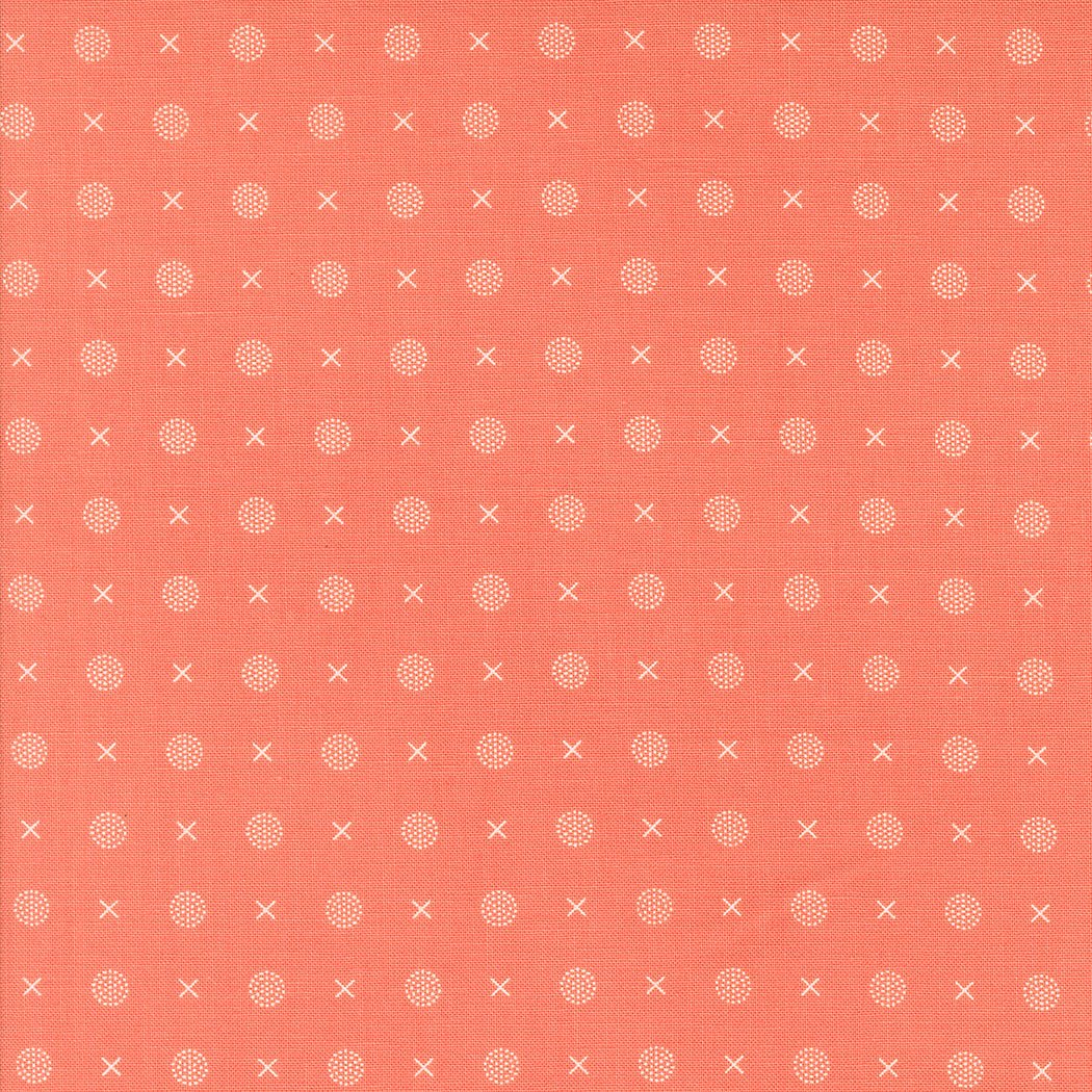 Abloom by Corey Yoder coral fabric with white X and dotted circle pattern for quilting
