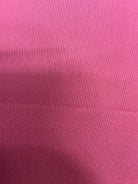 5-yard fabric cuts in assorted solid colors displayed for sale