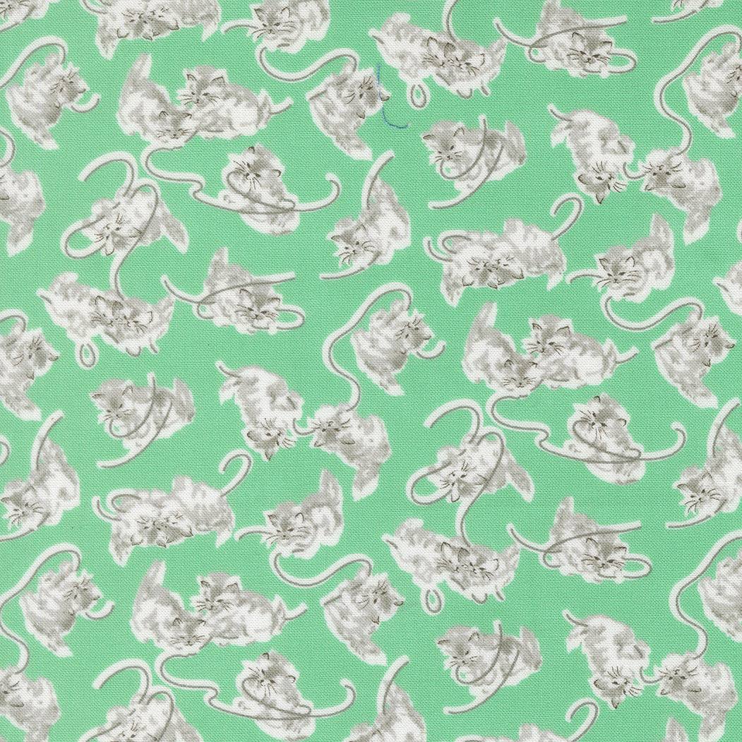 A Cat Named Stitch fabric featuring Georgie Novelty Cat Kitten in green by Camille Roskelley for Moda Fabrics