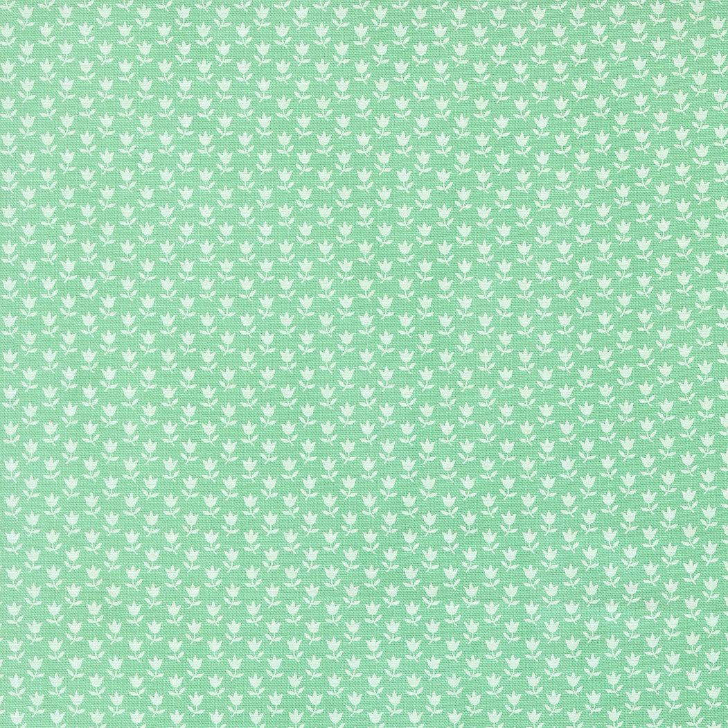 Green floral fabric "A Cat Named Stitch" by Camille Roskelley featuring tulip prints from Moda Fabrics