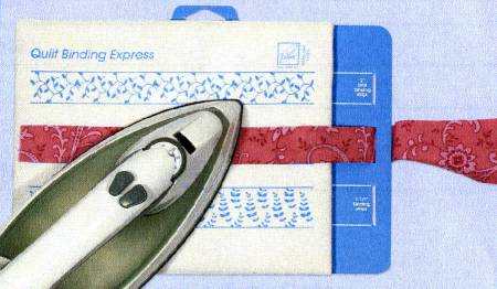 June Tailor Quilt Binding Express tool with iron and red fabric strip on blue cutting mat for pressing quilt binding strips