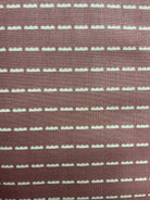 Bundle of colorful 5-yard fabric cuts for sale on display