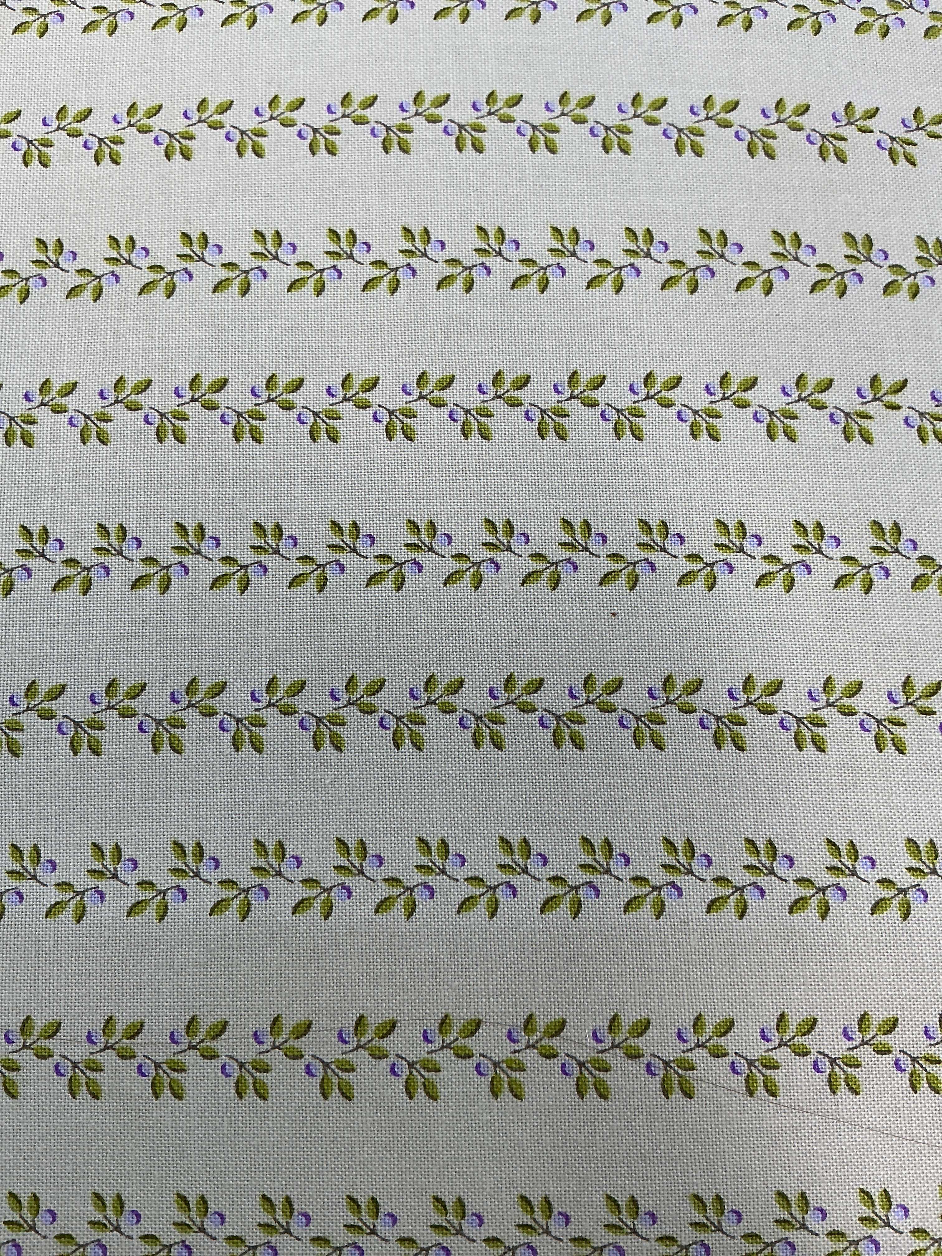 Colorful fabric rolls displayed for quilt backing sale at Bella Rose Quilts