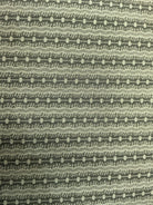 Rolls of 5-yard fabric cuts on sale stacked in a store