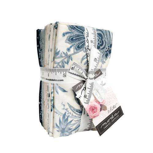 Breathtaking Blues Fat Eighth Bundle by 3 Sisters featuring 30 blue and cream fabric pieces tied with Moda Fabrics ribbon