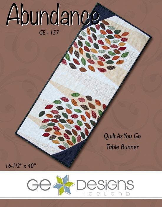 Abundance Table Runner quilt pattern with leaf fabric scraps and fat quarters measuring 16-1/2 by 40 inches