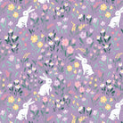 Bunny Blossoms fabric with white bunnies and colorful flowers on purple background by Dominika Godette