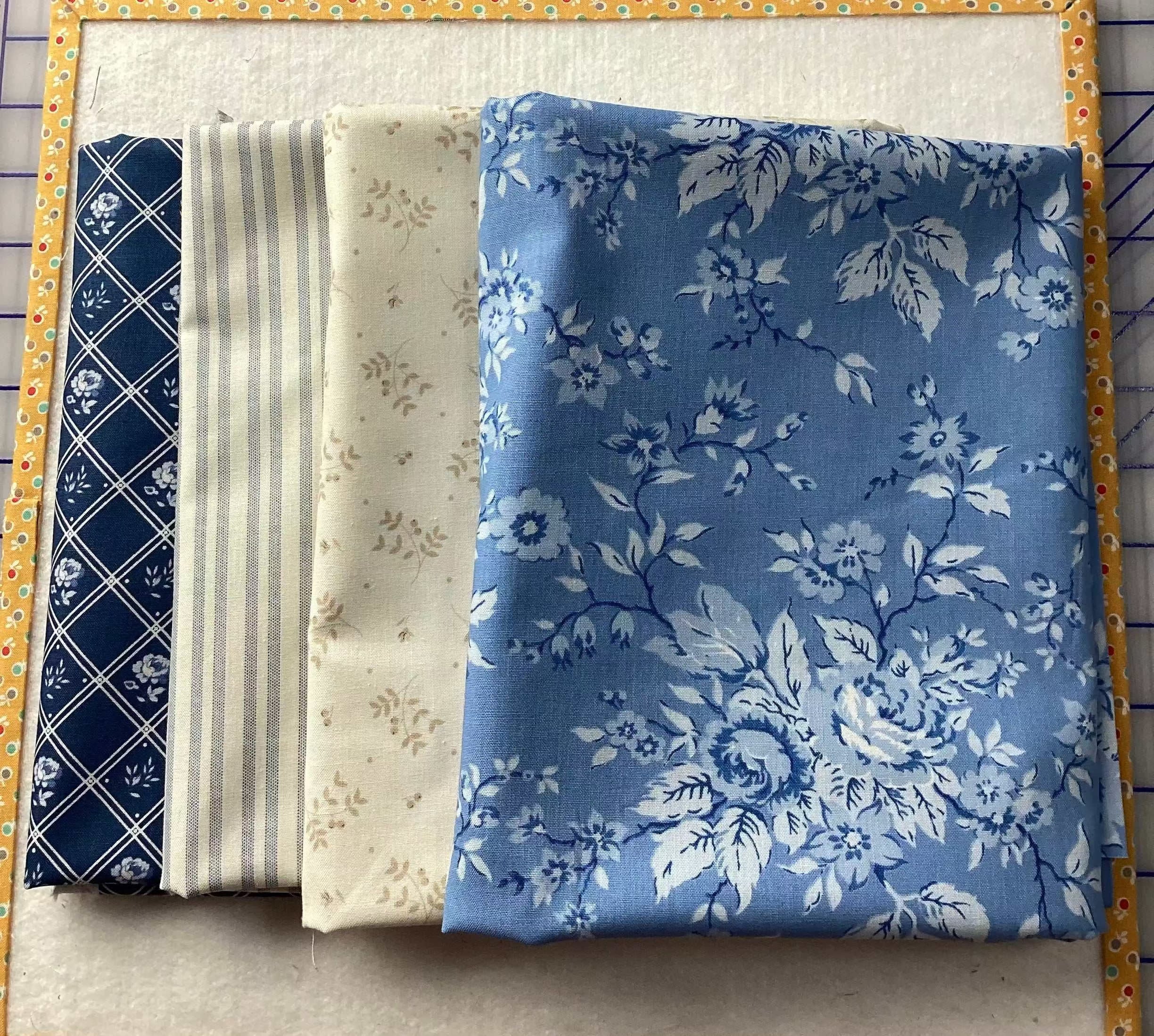 4-YARD QUILT fabric pieces with blue floral, beige floral, striped, and navy diamond patterns totaling four yards