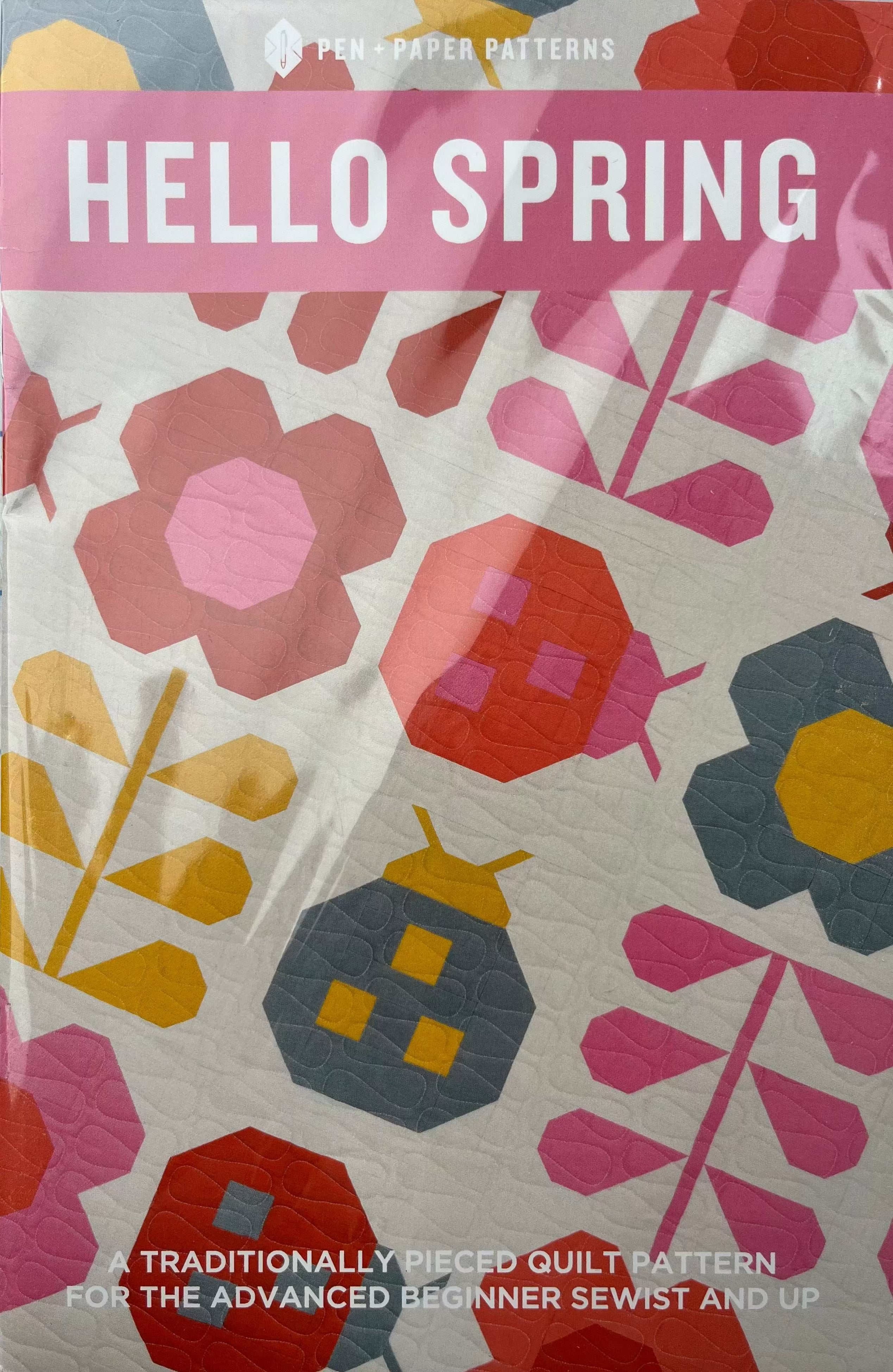Hello Spring quilt pattern by Pen + Paper Patterns with colorful floral and leaf designs