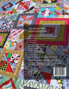 Wanderer's Wife Quilt Pattern by Jen Kingwell featuring colorful geometric blocks on concrete with graffiti background