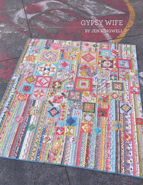 Wanderer's Wife Quilt Pattern by Jen Kingwell with colorful geometric blocks on concrete background