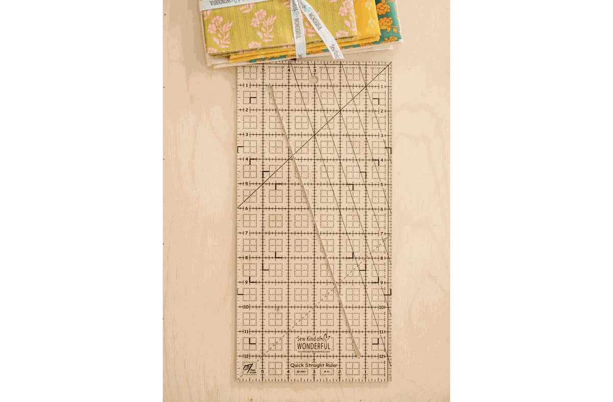 Quick Straight Ruler™ SKW-QSR by Sew Kind of Wonderful with angled slot and square dot grids for precise fabric cutting and squaring.