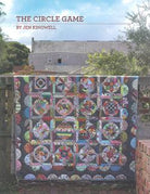 The Circle Game Quilt Pattern featuring 16 unique circular blocks in a striking layout for curved piecing skills