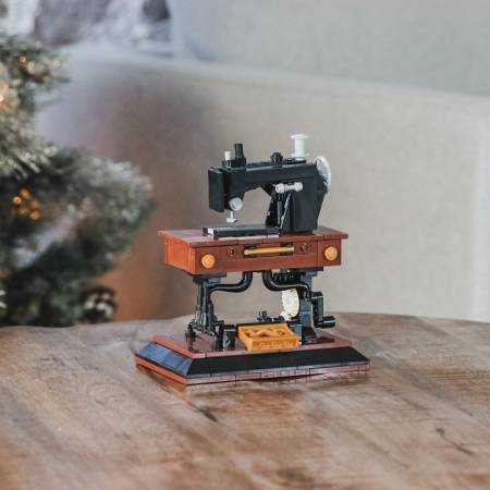 Mini vintage sewing machine model built from 250+ piece building block set on wooden table