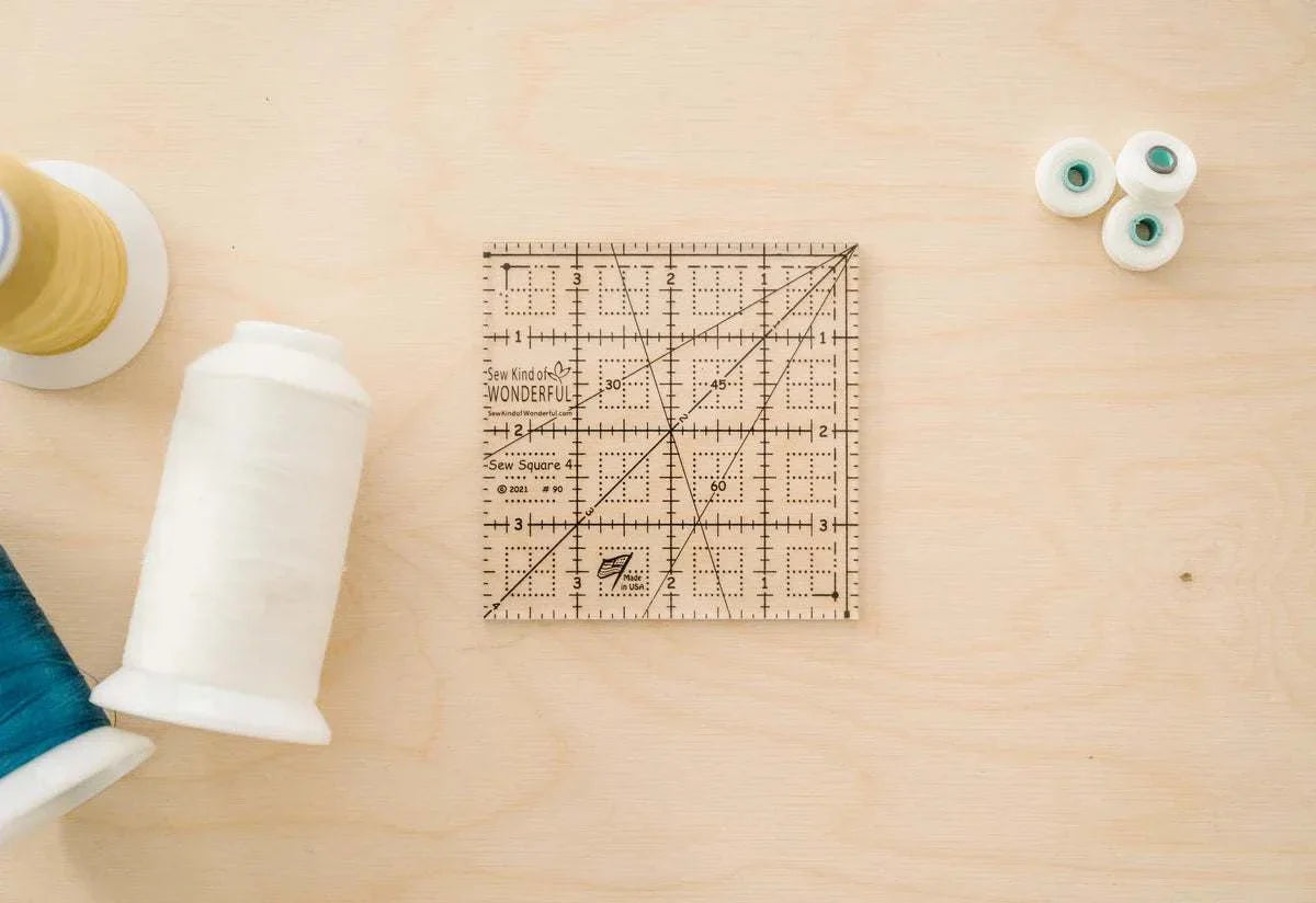 Sew Square 4™ clear acrylic 4x4 inch quilting ruler with black measurement lines and unique marks for squaring units