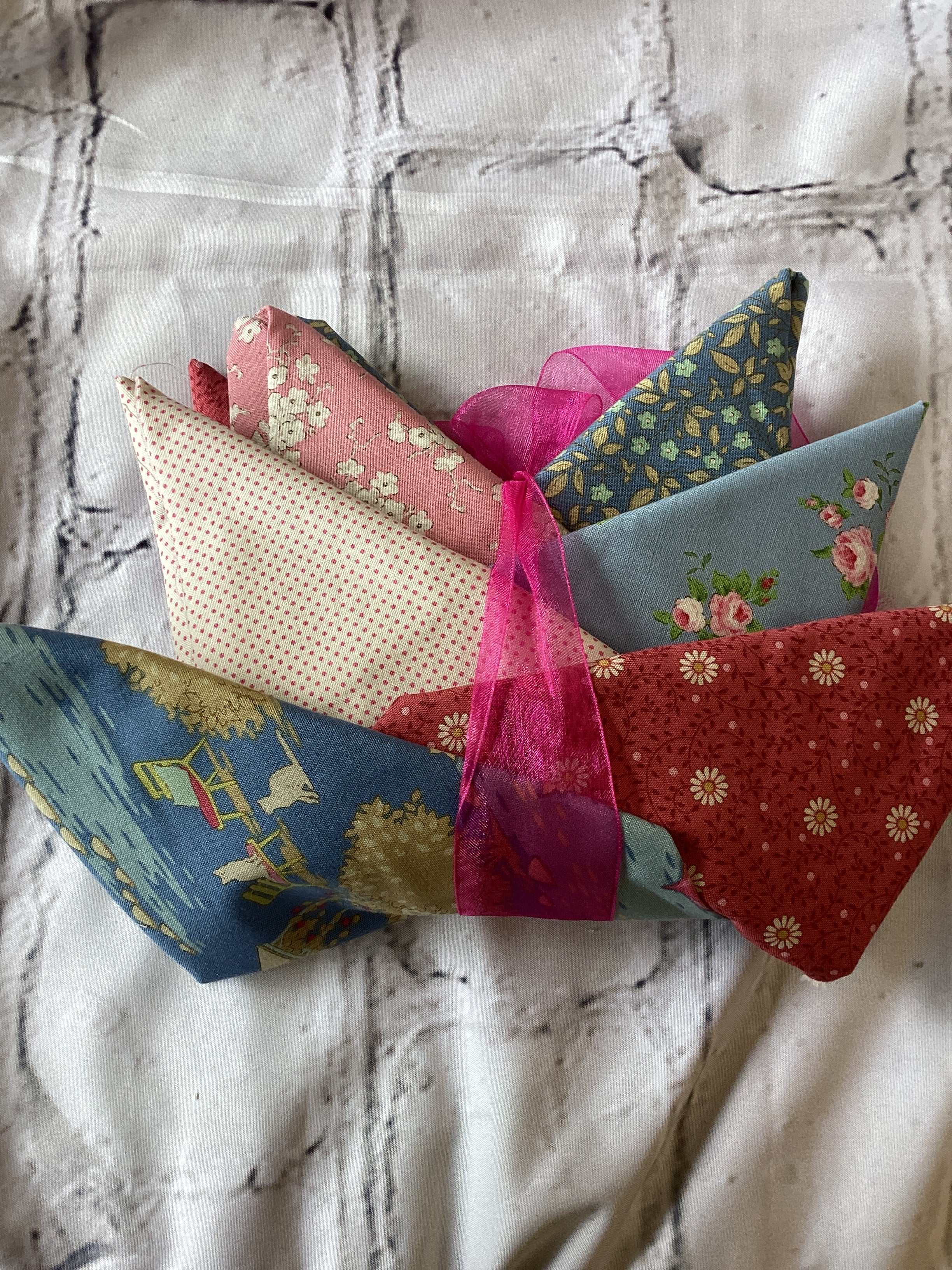 M50 Starry Night Bundle fabric bundle curated by Bella Rose Quilts with floral and patterned textiles wrapped in pink ribbon