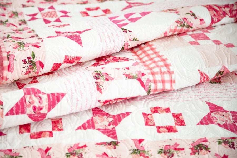 Close-up of folded Hope in Bloom Quilt Kit featuring pink and white breast cancer awareness design