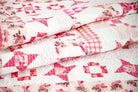 Close-up of folded Hope in Bloom Quilt Kit featuring pink and white breast cancer awareness design