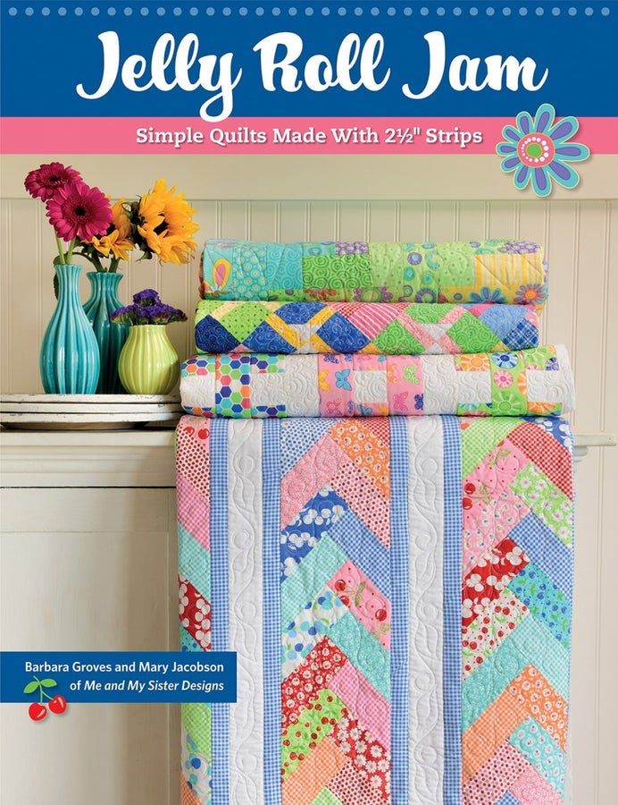 Jelly Roll Jam quilt patterns with colorful stacked quilts and floral vases on a table