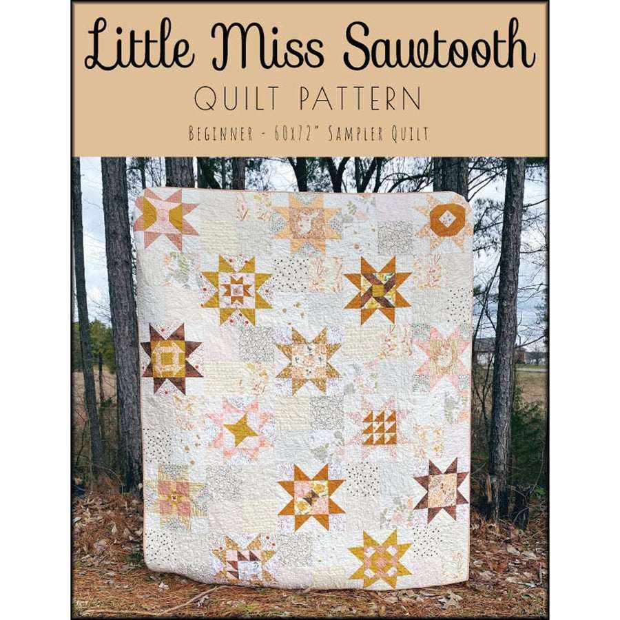 Little Miss Sawtooth quilt pattern featuring 60x72" beginner sampler quilt with star designs in earth tones displayed outdoors